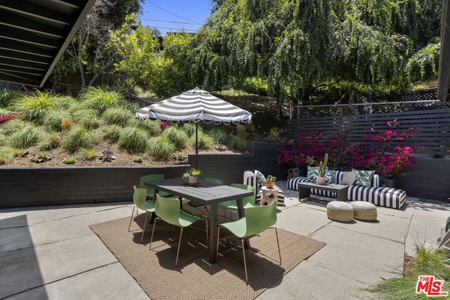 a patio with a table and chairs