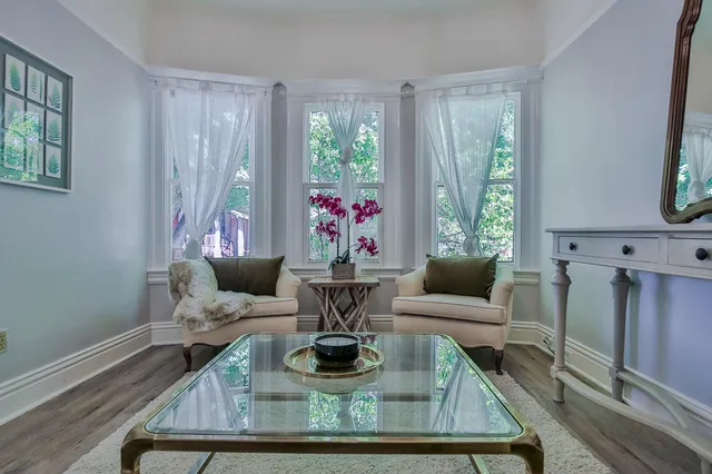 a living room with furniture and a large window