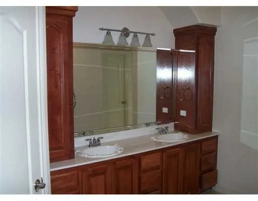a bathroom with a double vanity sink and a mirror