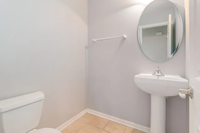 a bathroom with a sink toilet and mirror