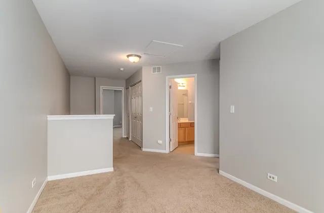an empty room with closet and wooden door