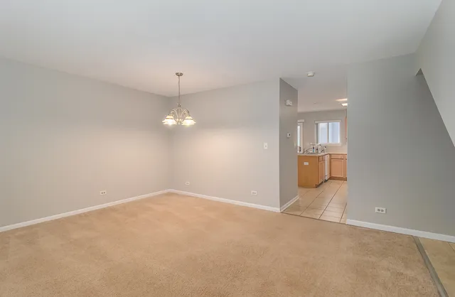 an empty room with an empty space and windows