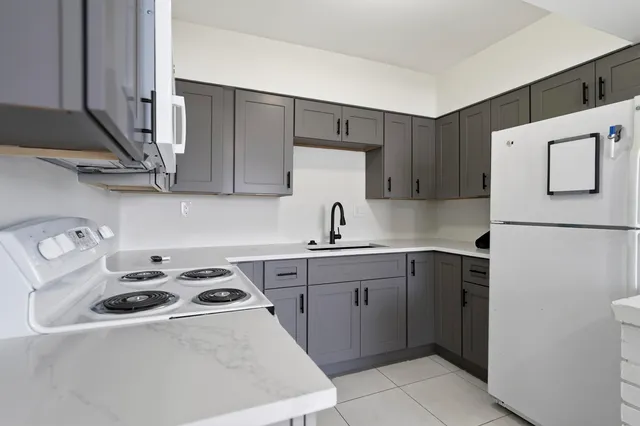 a kitchen with a sink a stove and refrigerator