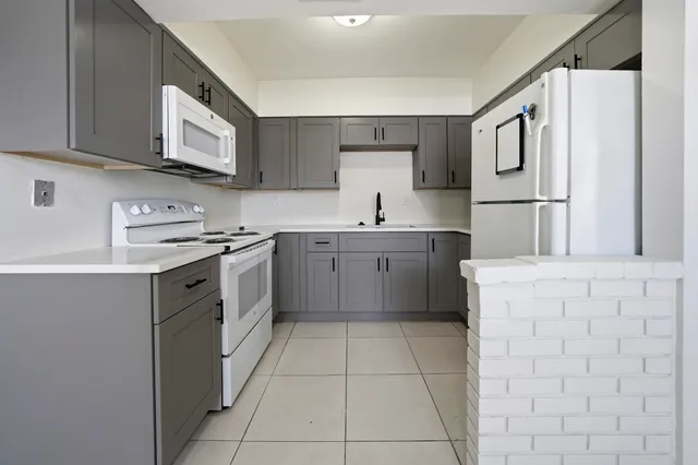 a kitchen with stainless steel appliances cabinets a sink and a stove