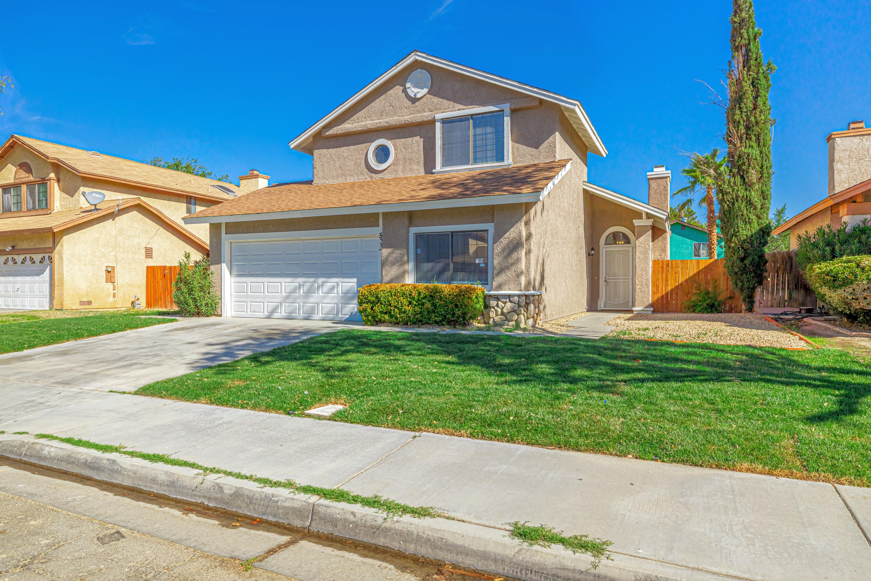 533 East Jackman Street Lancaster, CA 93535 - Photo 2 of 31 a front view of a house with a yard and garage
