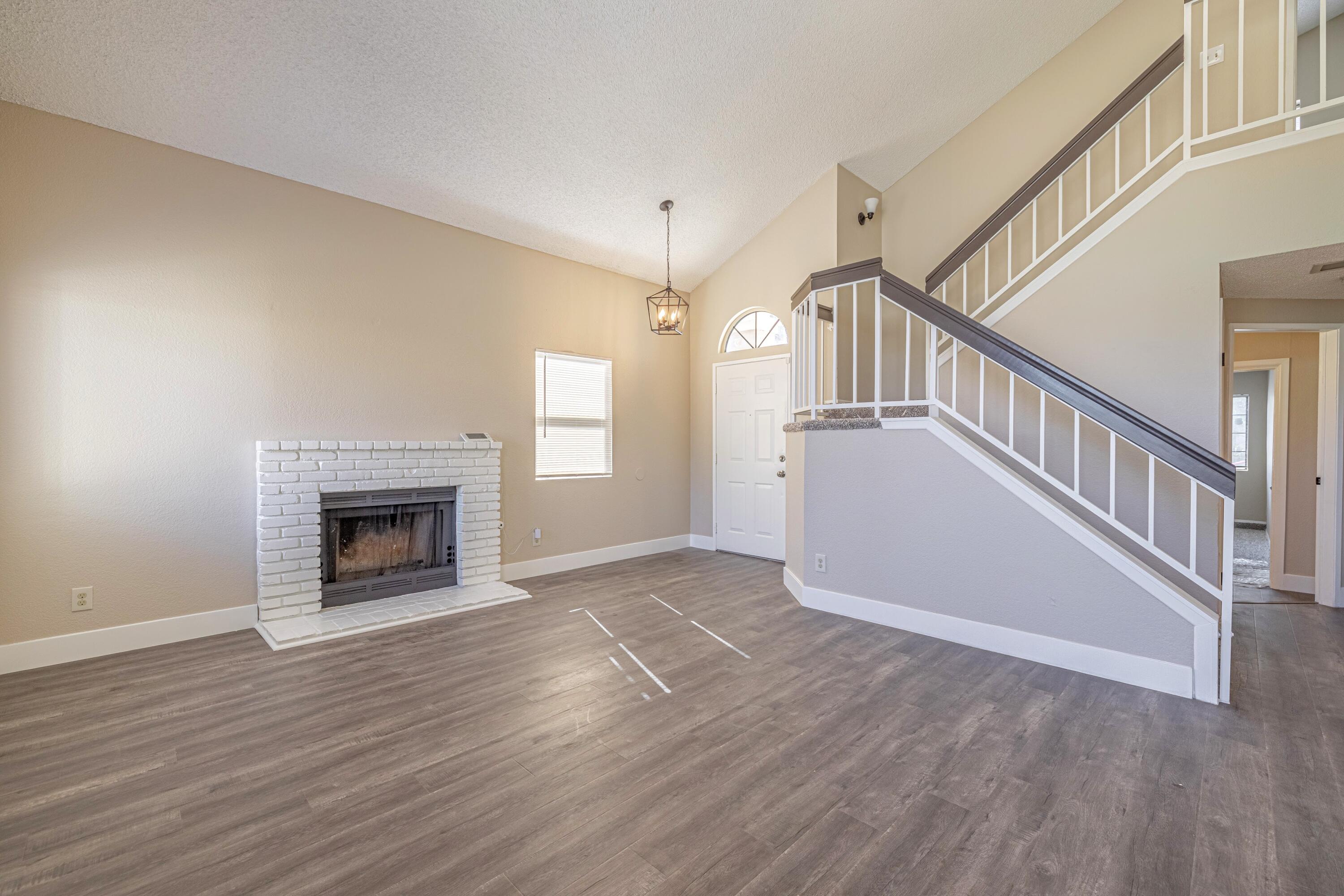 533 East Jackman Street Lancaster, CA 93535 - Photo 6 of 31 a view of an empty room with wooden floor fireplace and a window