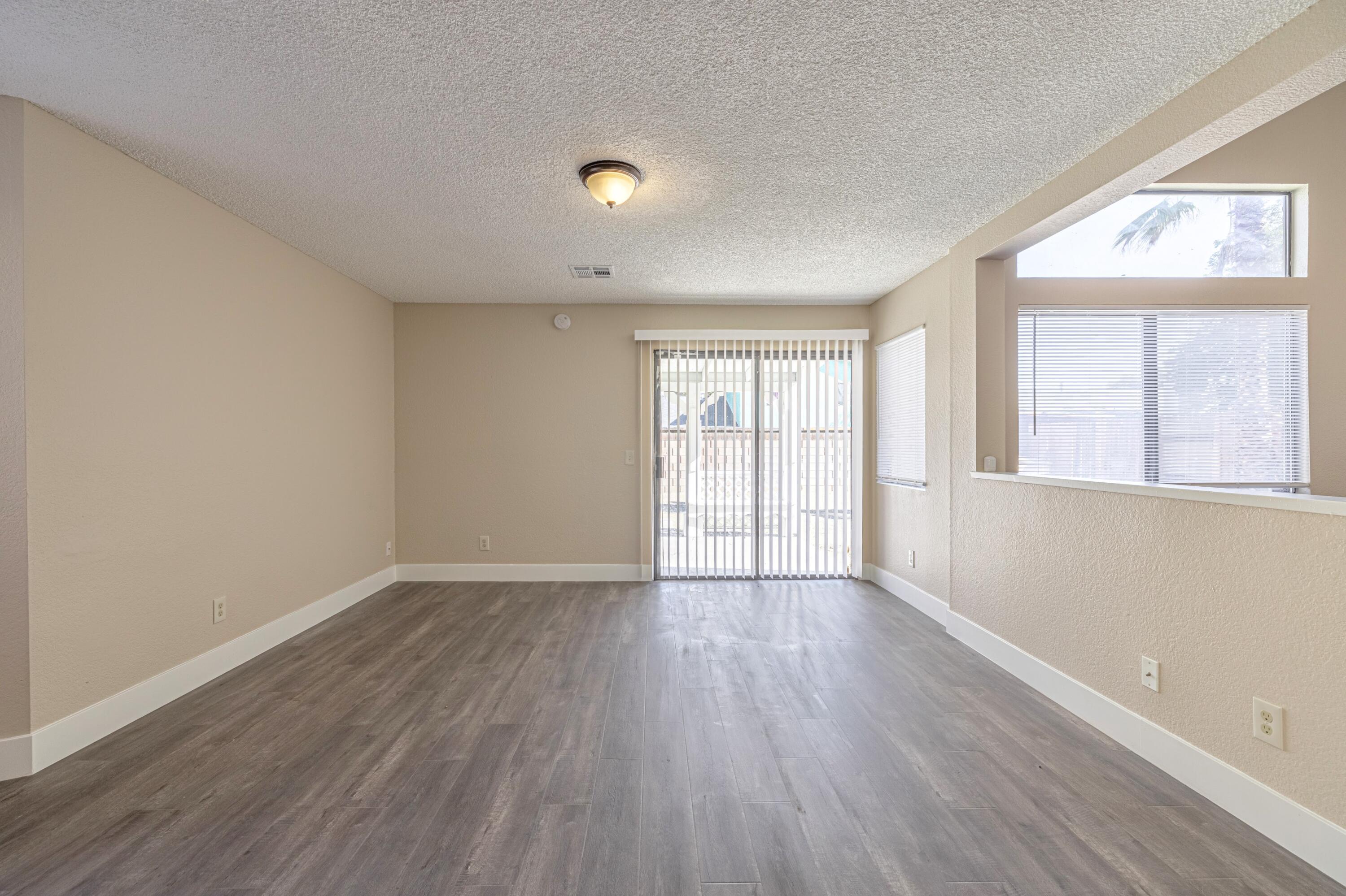 533 East Jackman Street Lancaster, CA 93535 - Photo 8 of 31 an empty room with wooden floor and windows