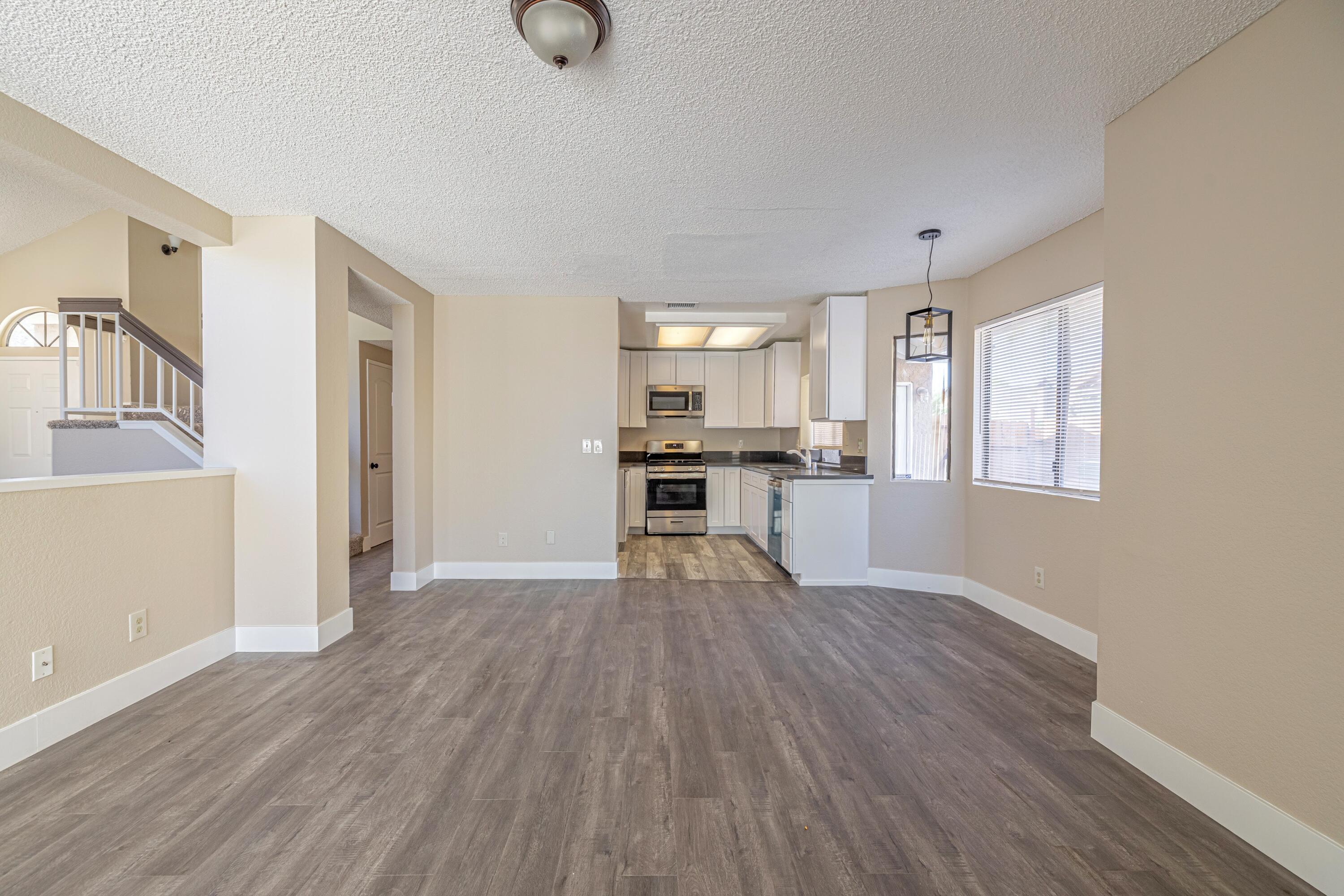 533 East Jackman Street Lancaster, CA 93535 - Photo 10 of 31 a view of a kitchen with a fridge wooden floor and a window