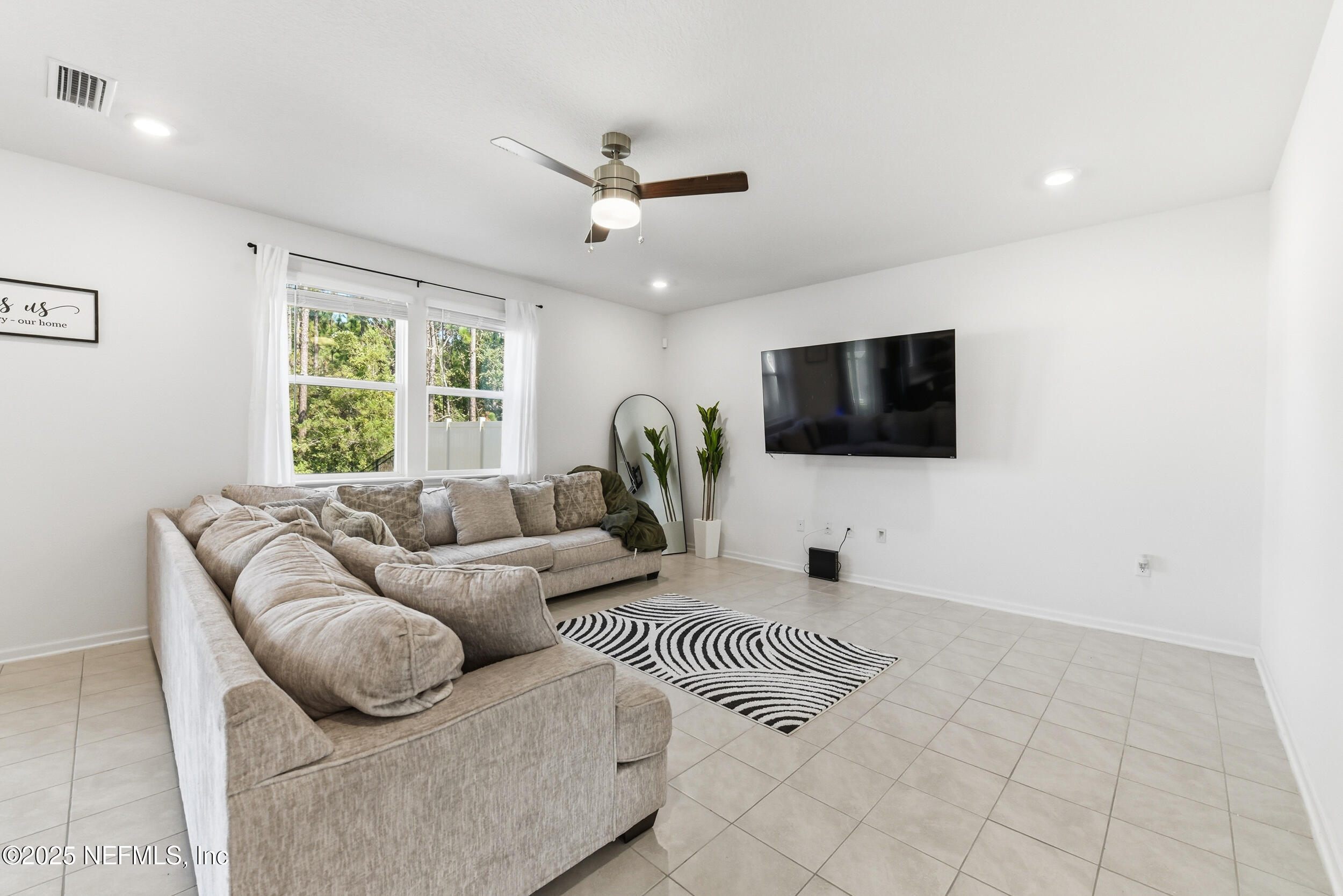 11183 Stapleton Drive Jacksonville, FL 32222 - Photo 12 of 43 a living room with furniture and a flat screen tv