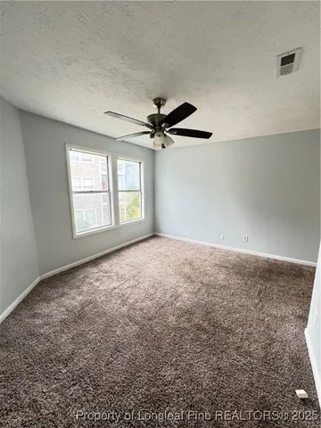 a view of a big room with closet and chandelier fan