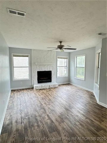 a kitchen with stainless steel appliances granite countertop a refrigerator a stove a sink and a microwave