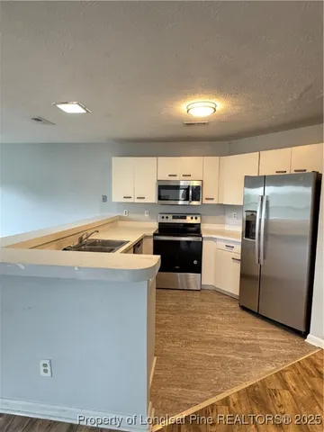 a kitchen with a white cabinets and white appliances