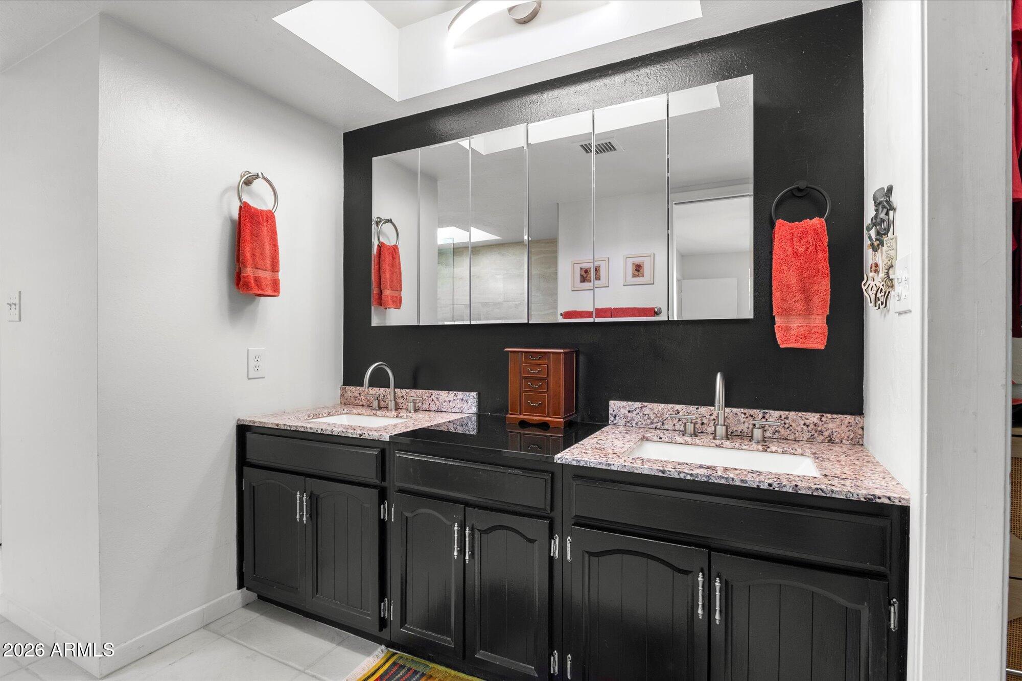 7005 North Barbados Place Phoenix, AZ 85021 - Photo 27 of 42 a bathroom with a sink vanity and a mirror