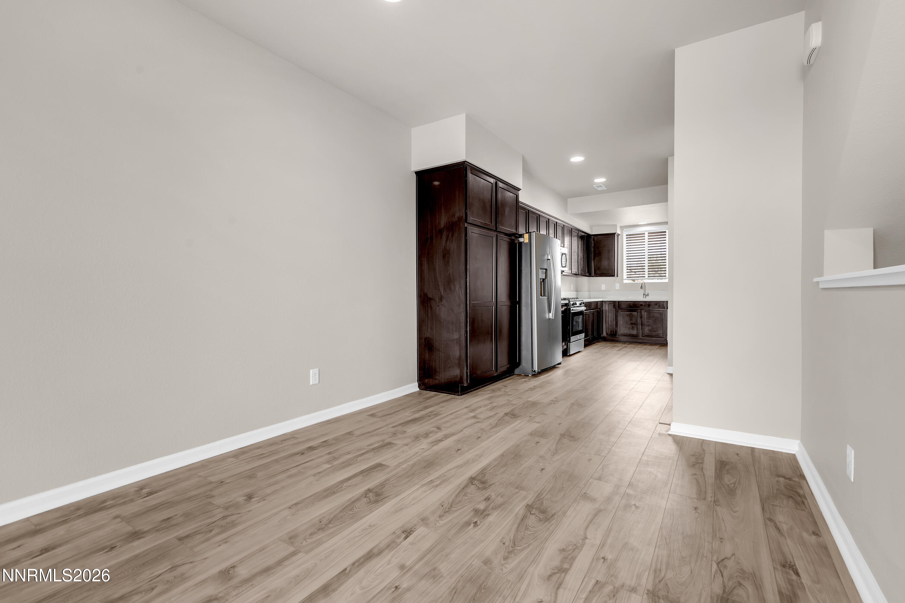 2150 Altamira Drive Reno, NV 89523 - Photo 6 of 21 a view of empty room with wooden floor and kitchen