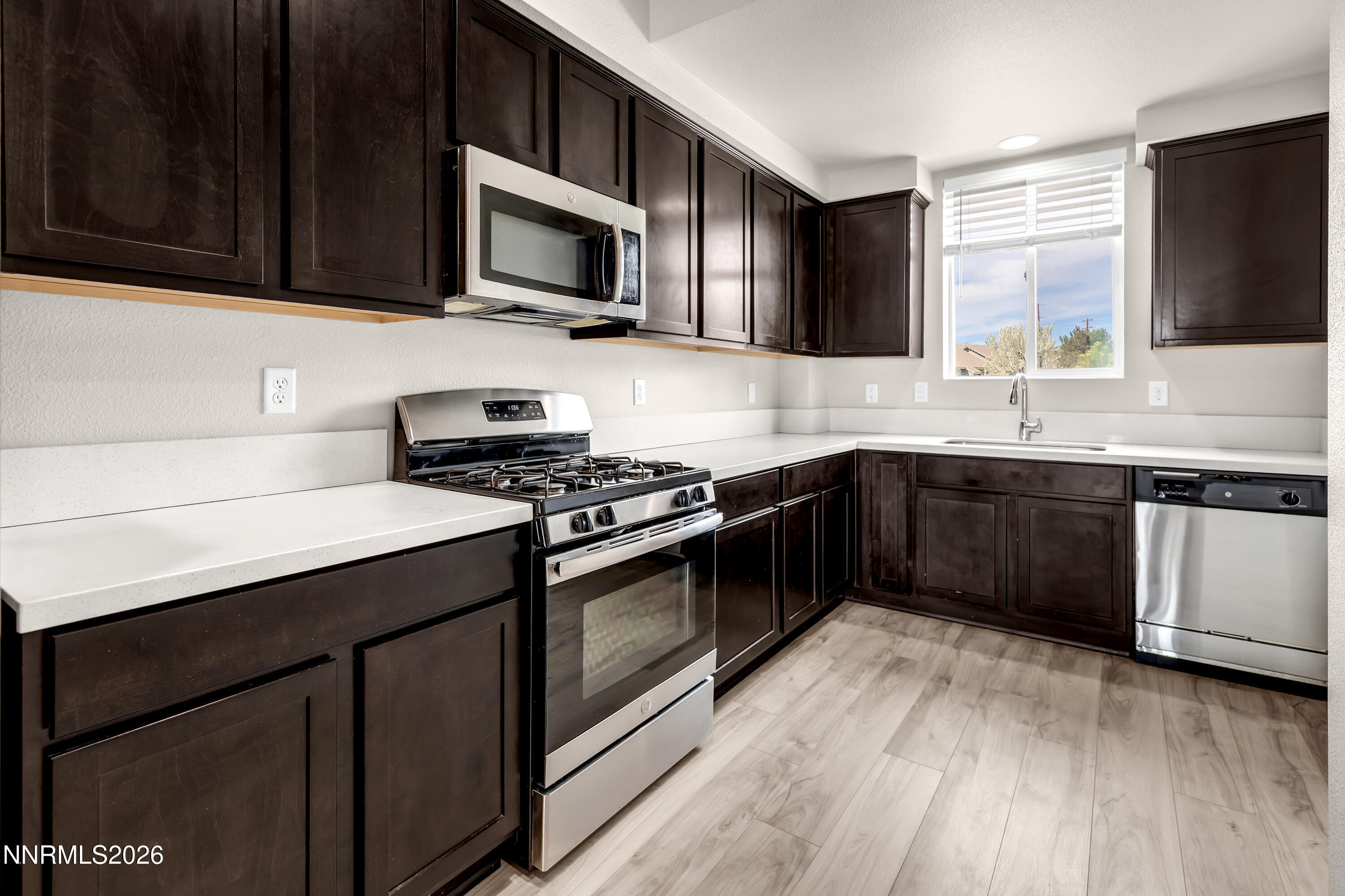 2150 Altamira Drive Reno, NV 89523 - Photo 7 of 21 a kitchen with stainless steel appliances a sink dishwasher stove and microwave