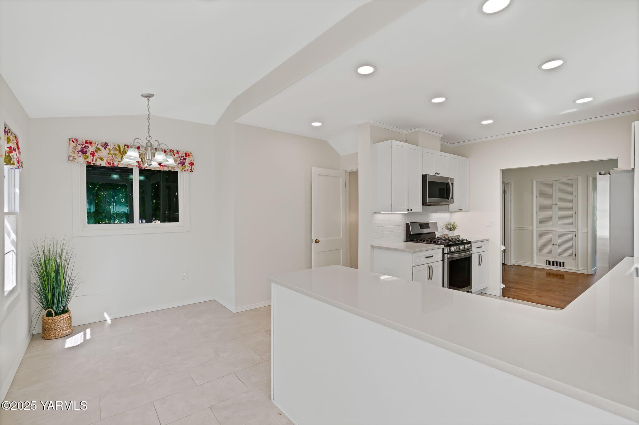 3310 Summitview Avenue Yakima, WA 98902 - Photo 11 of 39 a kitchen with stainless steel appliances kitchen island granite countertop a stove a sink and a refrigerator