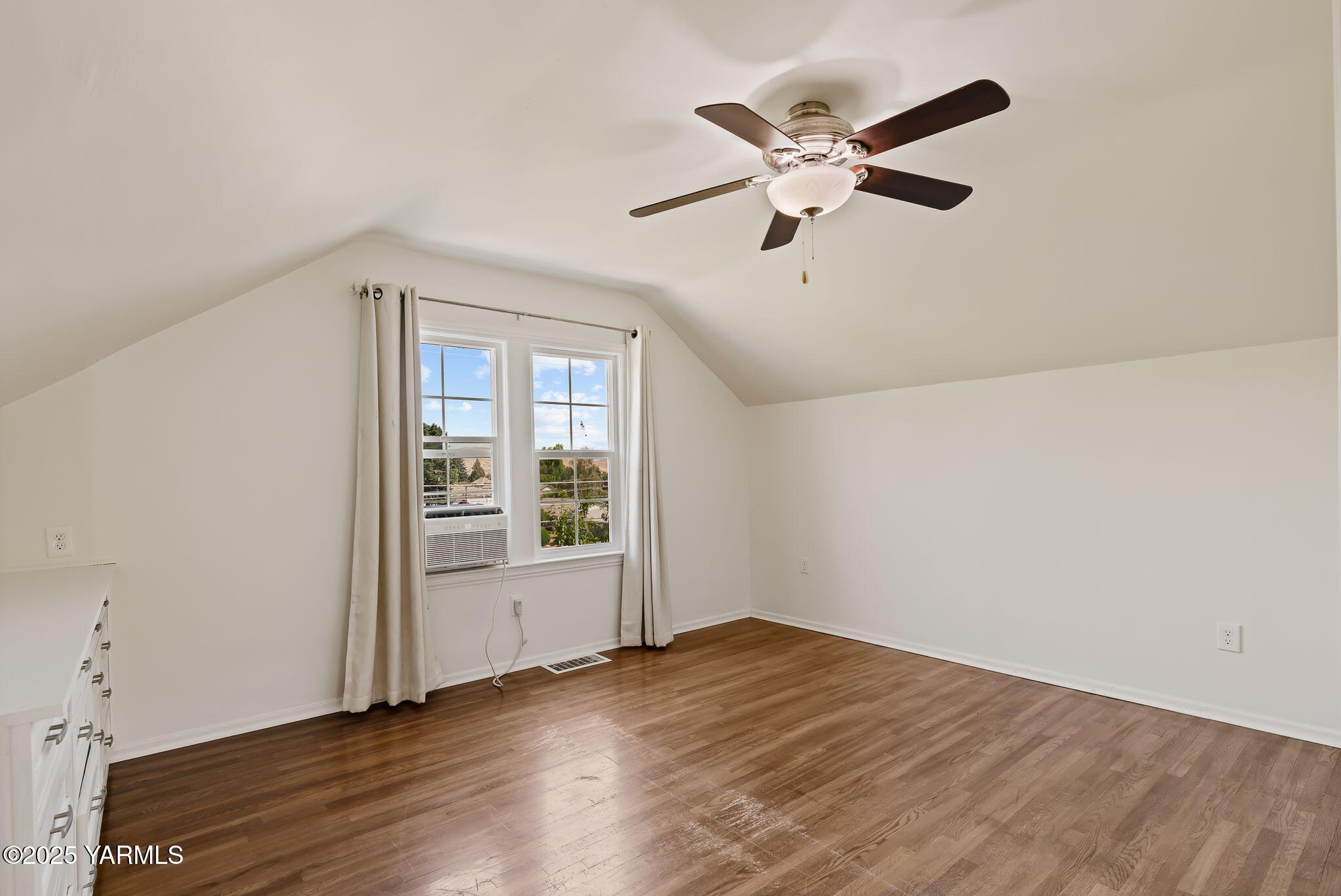 3310 Summitview Avenue Yakima, WA 98902 - Photo 22 of 39 an empty room with wooden floor fan and windows