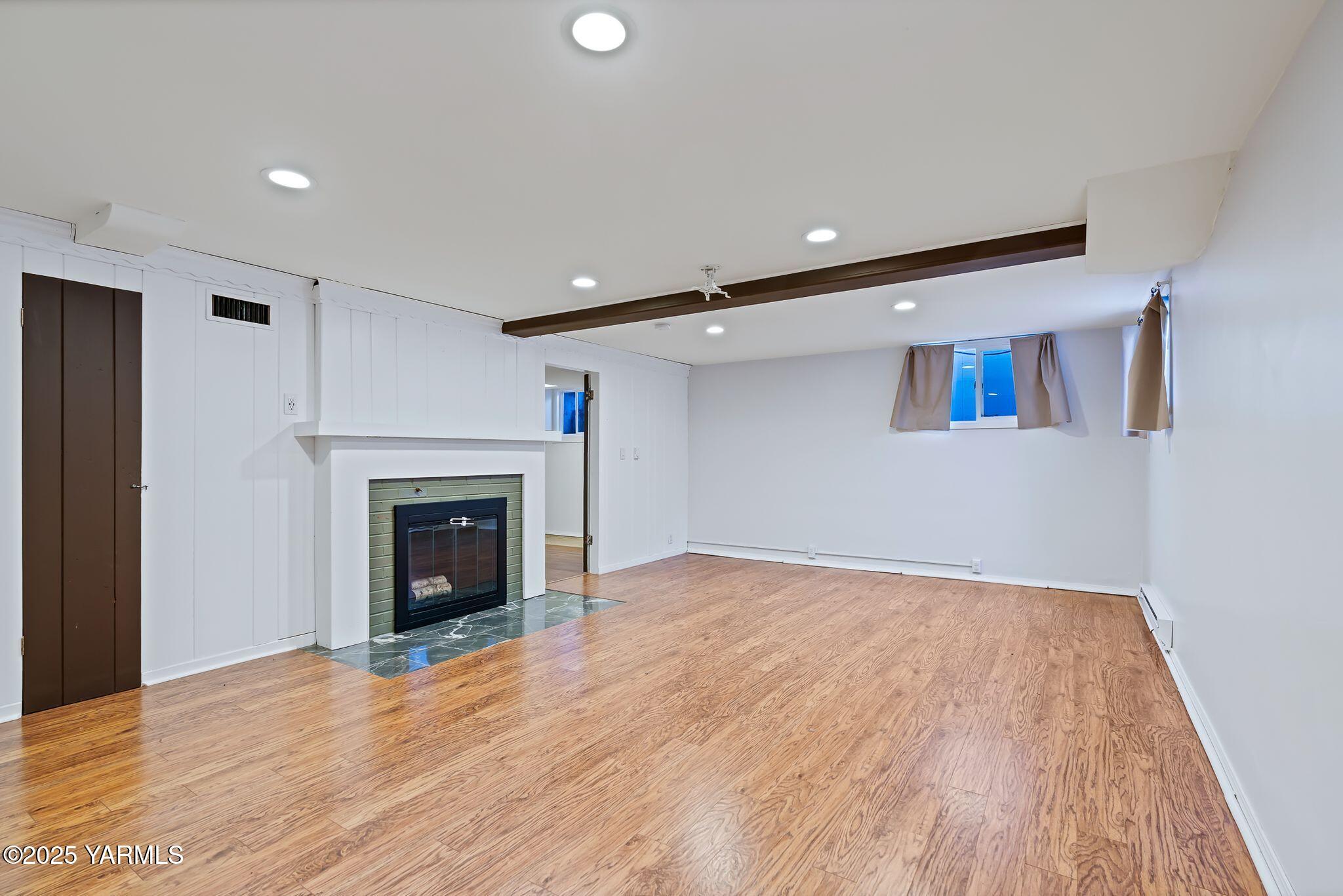 3310 Summitview Avenue Yakima, WA 98902 - Photo 27 of 39 a view of empty room with wooden floor and fireplace
