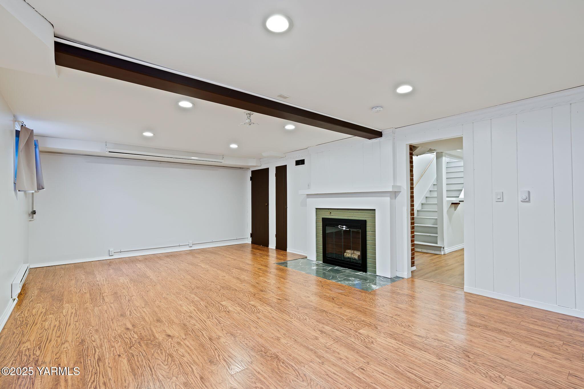 3310 Summitview Avenue Yakima, WA 98902 - Photo 28 of 39 a view of an empty room with wooden floor and a fireplace