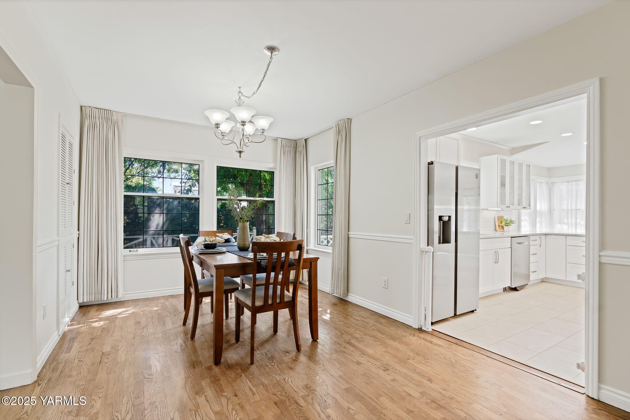 3310 Summitview Avenue Yakima, WA 98902 - Photo 7 of 39 a dining room with furniture a chandelier and wooden floor