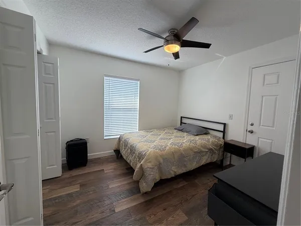 a bedroom with bed and a chandelier