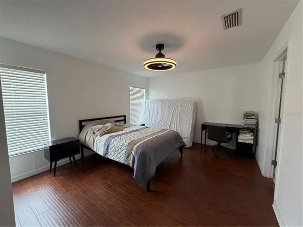a bedroom with a bed and a chandelier