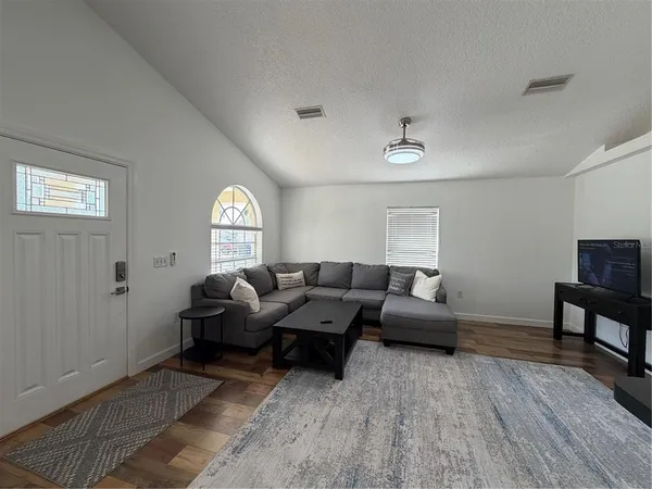a living room with furniture and a window