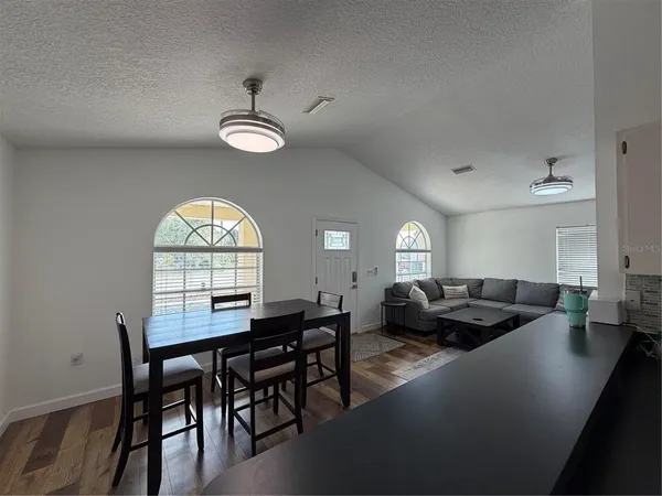 a view of a dining room with furniture and a large window