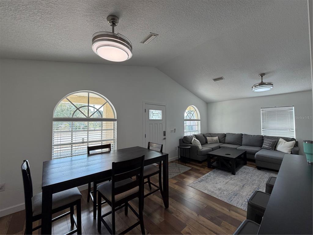 2723 West Arch Street Tampa, FL 33607 - Photo 7 of 14 a living room with furniture a large window and a dining table