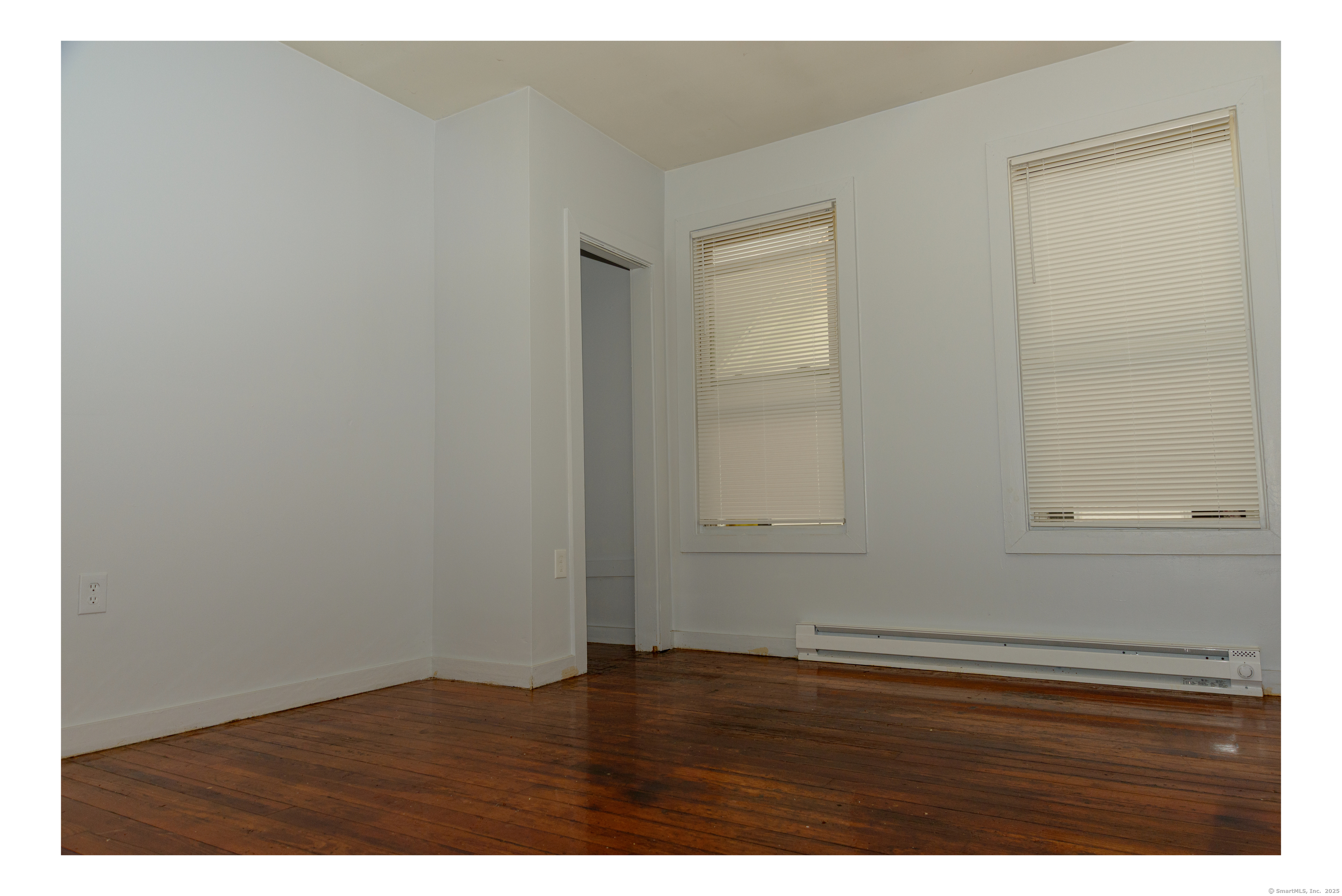 59 Ward Street, Unit 3 Waterbury, CT 06704 - Photo 11 of 19 a view of an empty room with wooden floor
