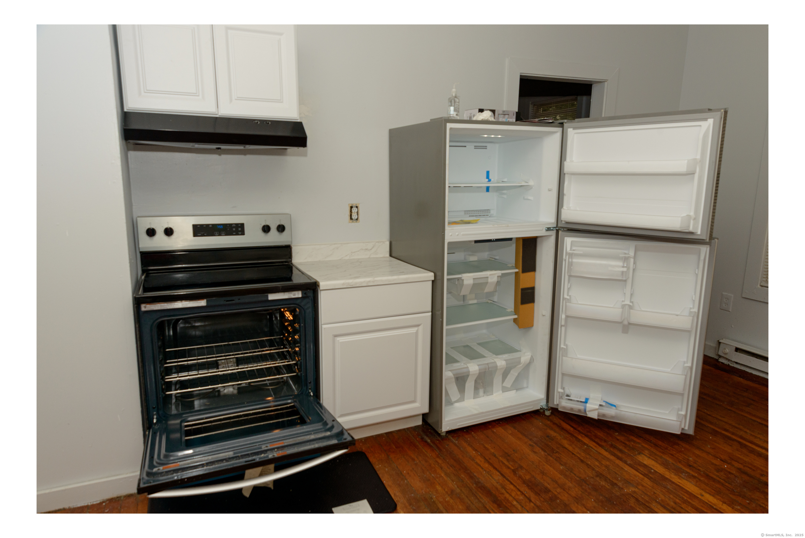 59 Ward Street, Unit 3 Waterbury, CT 06704 - Photo 4 of 19 a kitchen with a refrigerator and a stove top oven