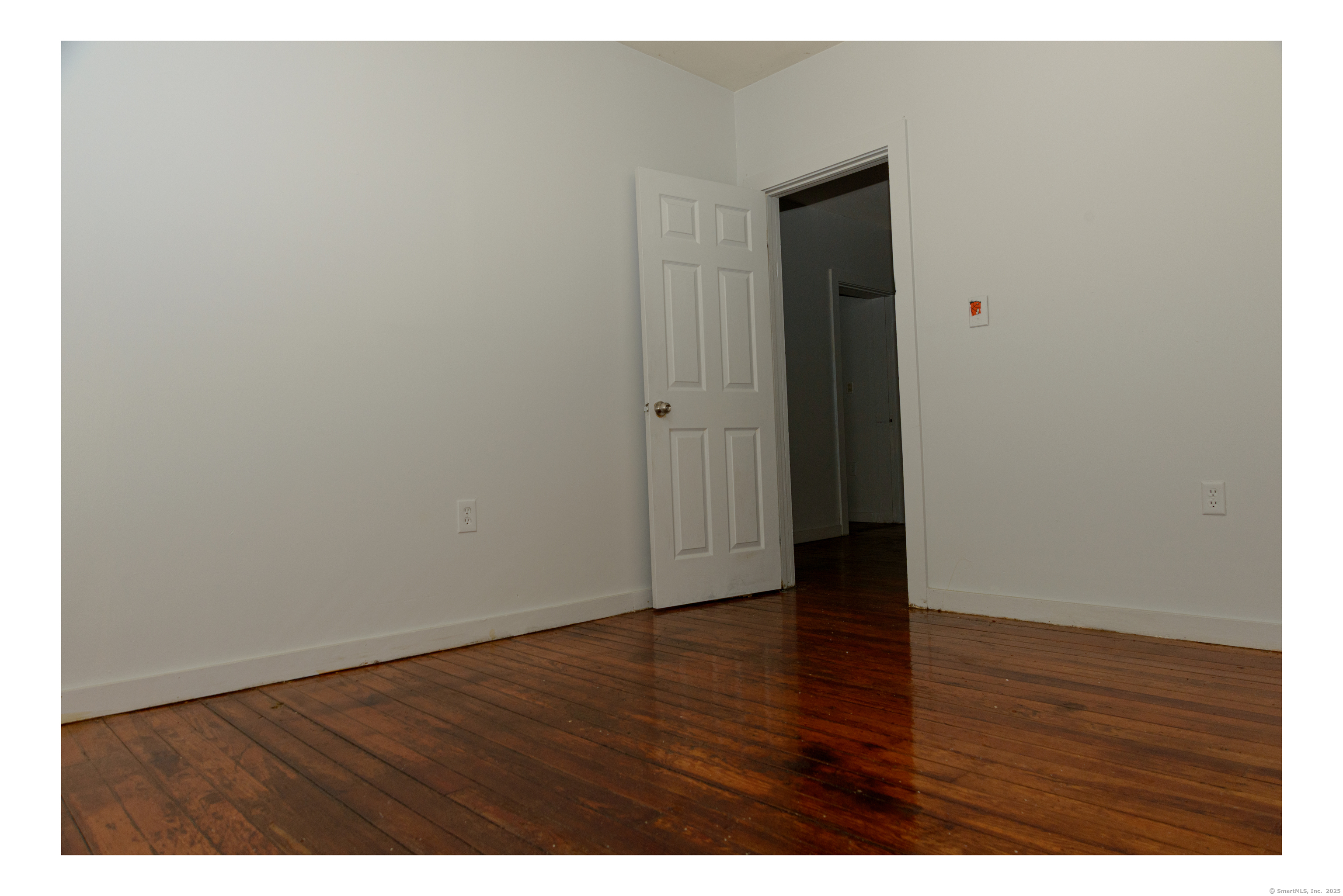 59 Ward Street, Unit 3 Waterbury, CT 06704 - Photo 10 of 19 a view of an empty room with wooden floor