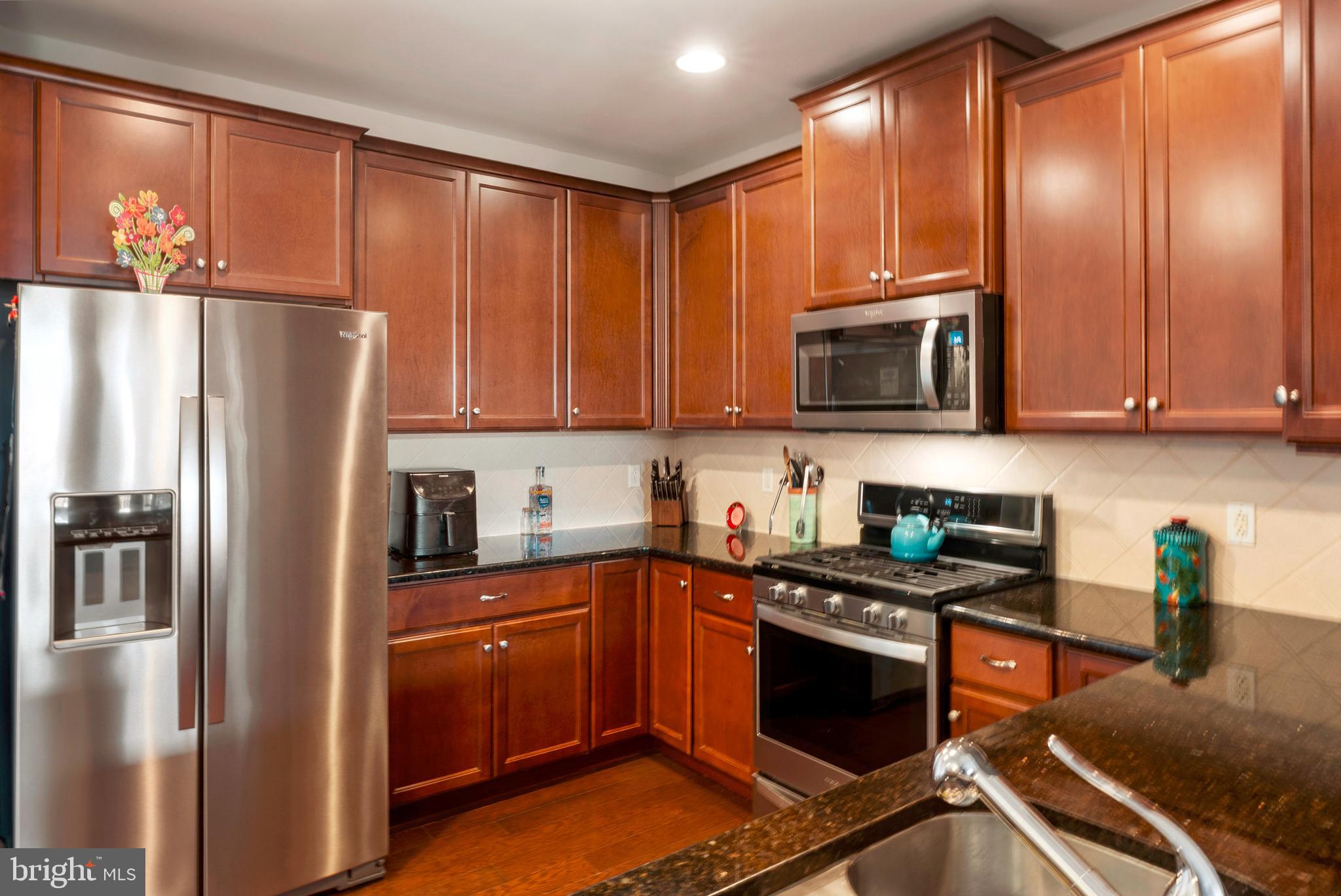 531 Carson Terrace Huntingdon Valley, PA 19006 - Photo 8 of 46 a kitchen with stainless steel appliances granite countertop a refrigerator stove top oven a sink and dishwasher