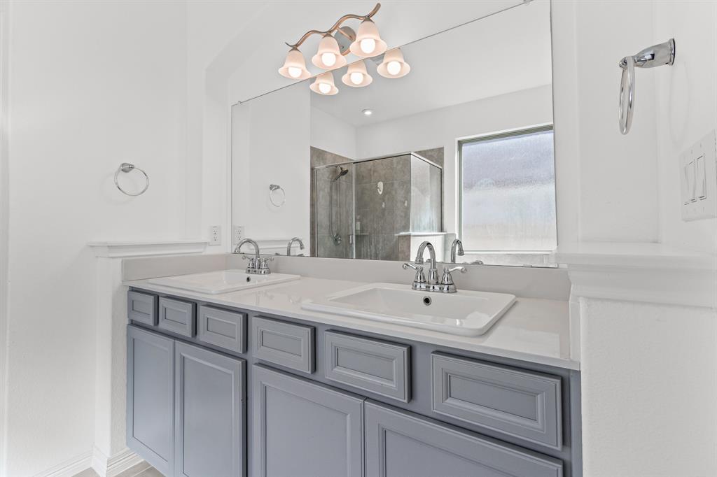 20520 Carries Ranch Road Pflugerville, TX 78660 - Photo 12 of 26 Bathroom featuring double vanity and a shower stall
