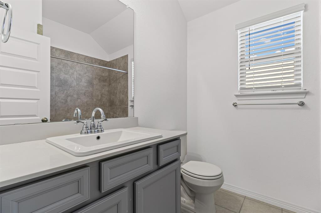 20520 Carries Ranch Road Pflugerville, TX 78660 - Photo 18 of 26 Full bath with vanity, lofted ceiling, light tile patterned floors, and a shower