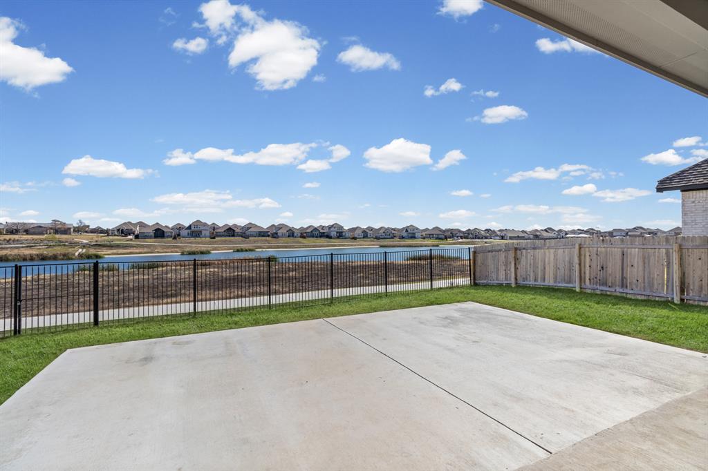 20520 Carries Ranch Road Pflugerville, TX 78660 - Photo 2 of 26 Fenced backyard featuring a residential view, a patio area, and a water view