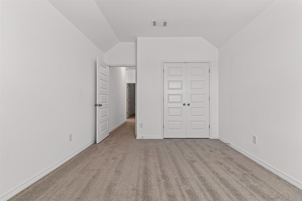 20520 Carries Ranch Road Pflugerville, TX 78660 - Photo 21 of 26 Unfurnished bedroom featuring carpet flooring, lofted ceiling, and a closet
