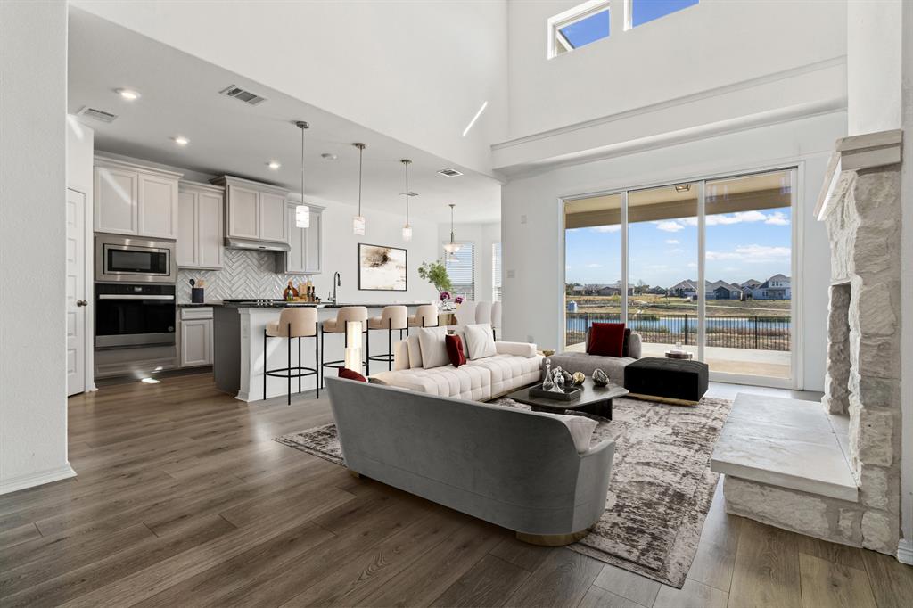 20520 Carries Ranch Road Pflugerville, TX 78660 - Photo 3 of 26 Living room featuring dark wood-type flooring, a water view, a high ceiling, and a residential view