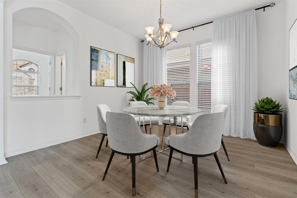 20520 Carries Ranch Road Pflugerville, TX 78660 - Photo 5 of 26 Dining room featuring light wood finished floors, suspended lighting, and healthy amount of natural light