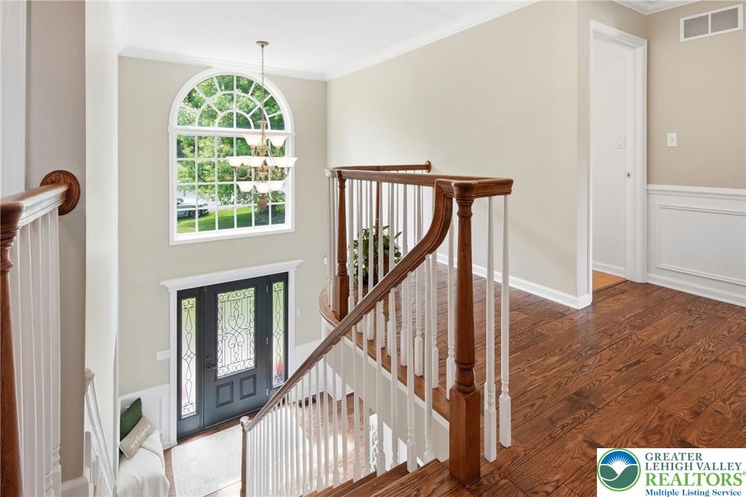 115 West Butternut Road Hellertown, PA 18055 - Photo 33 of 97 A grand entry with a sweeping staircase and a tall arched window create an impressive welcome.