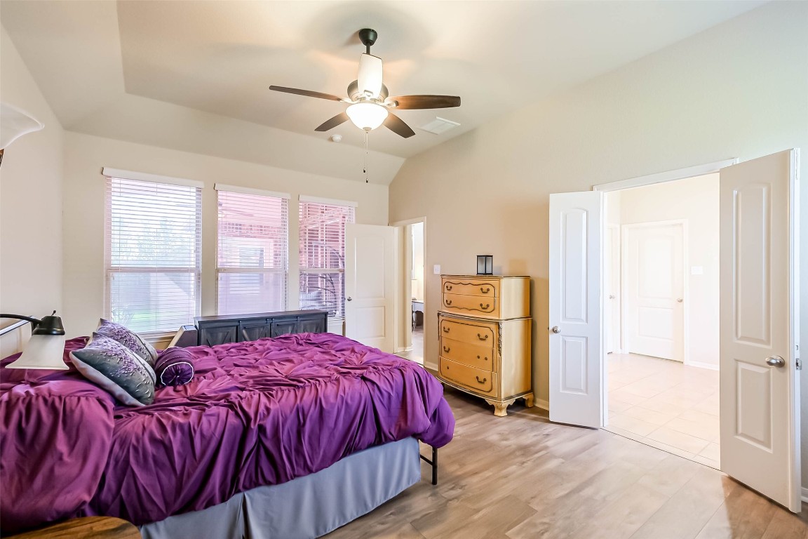 4718 Sedgewood Drive Rosenberg, TX 77471 - Photo 12 of 23 a spacious bedroom with a bed and a chandelier