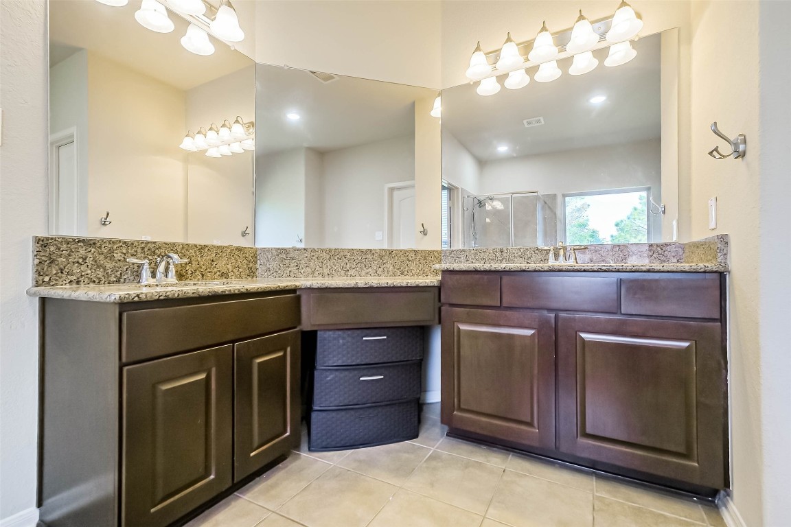 4718 Sedgewood Drive Rosenberg, TX 77471 - Photo 14 of 23 a kitchen with a granite countertop stove sink and cabinets