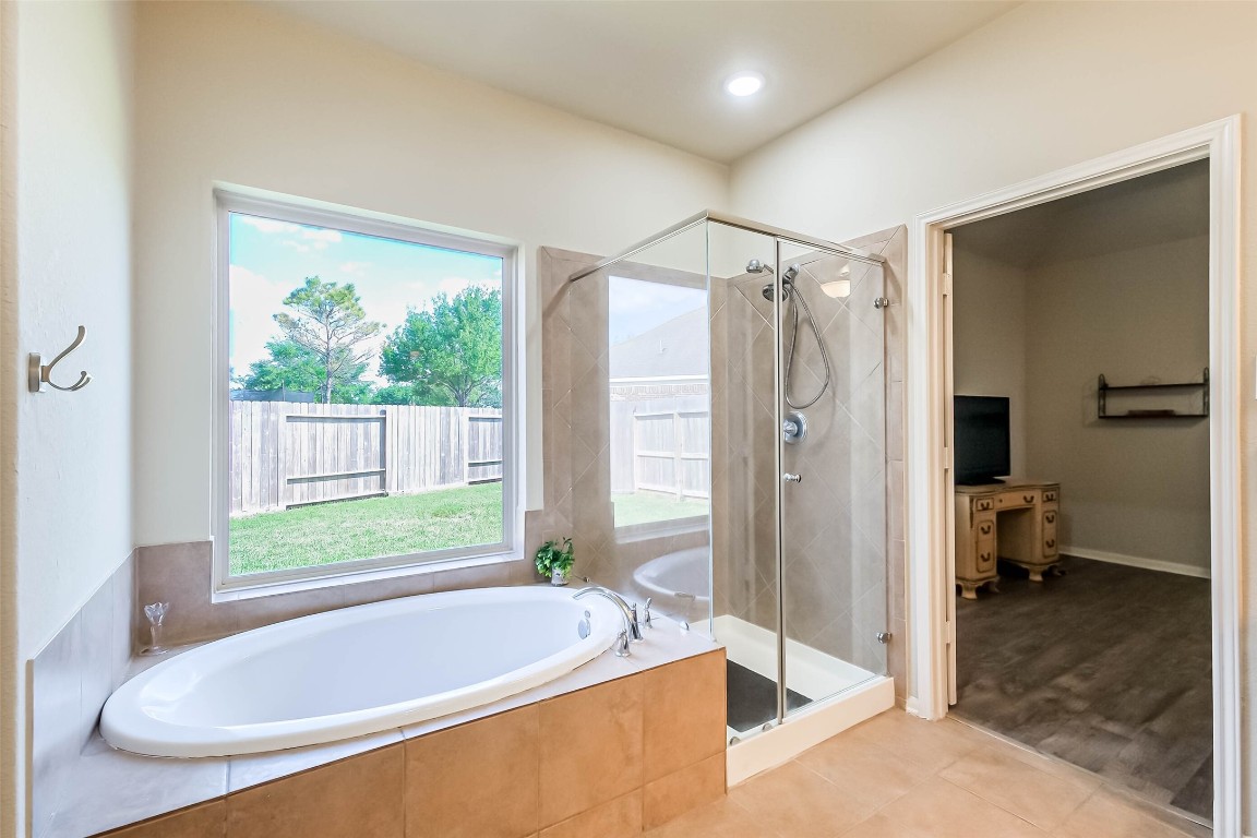 4718 Sedgewood Drive Rosenberg, TX 77471 - Photo 15 of 23 a bathroom with a tub a sink and shower