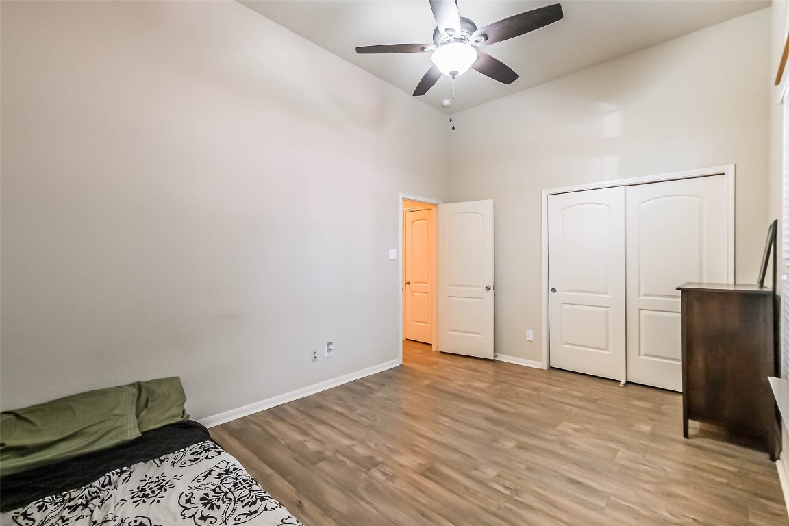 4718 Sedgewood Drive Rosenberg, TX 77471 - Photo 17 of 23 a view of an empty room with wooden floor and a ceiling fan