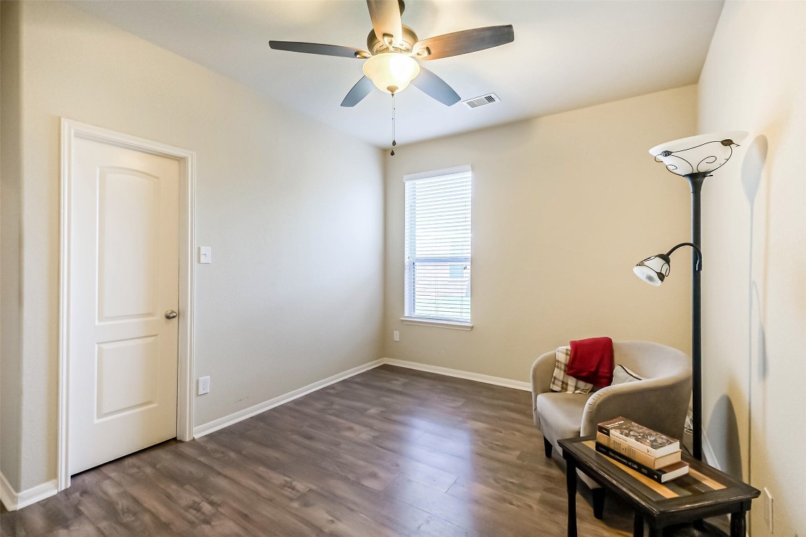 4718 Sedgewood Drive Rosenberg, TX 77471 - Photo 18 of 23 a view of a room with wooden floor closet and chandelier fan