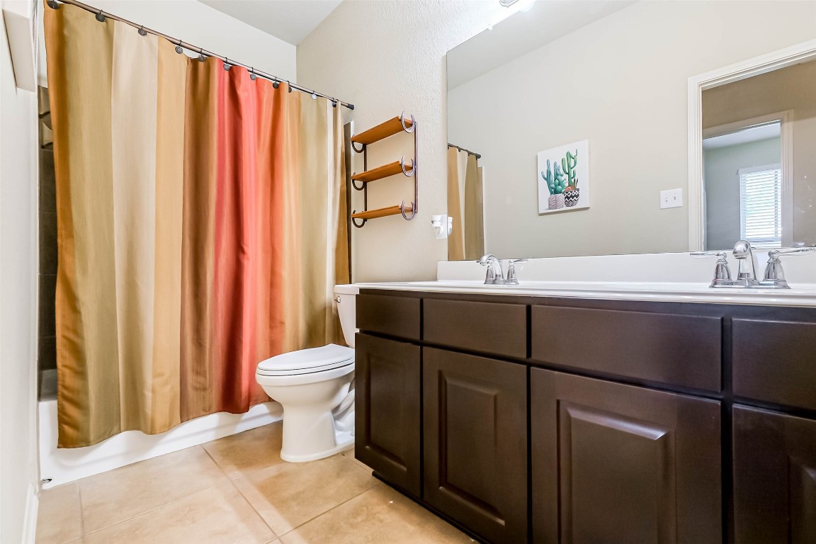 4718 Sedgewood Drive Rosenberg, TX 77471 - Photo 19 of 23 a bathroom with a granite countertop sink toilet and mirror