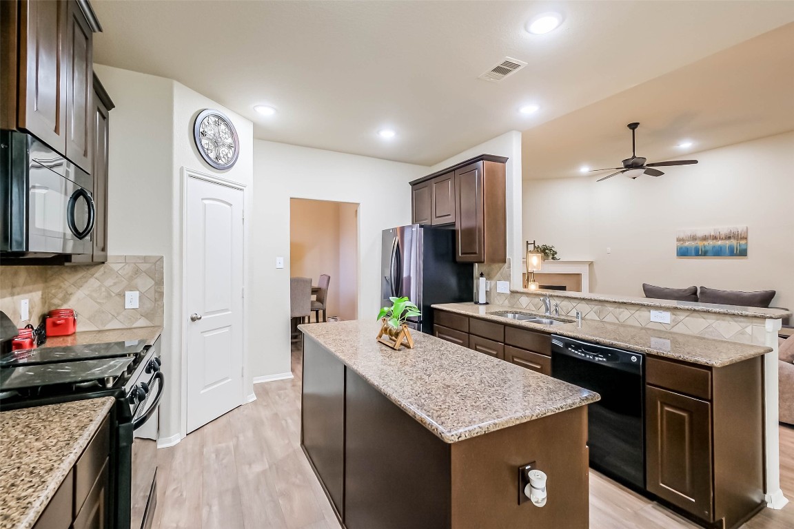 4718 Sedgewood Drive Rosenberg, TX 77471 - Photo 8 of 23 a kitchen with a stove and a refrigerator