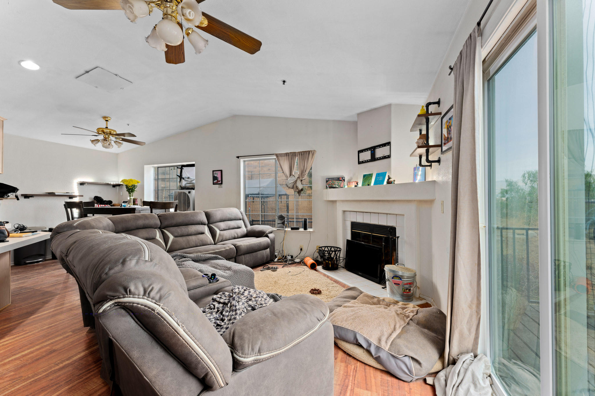 32035 Mountain Shadow Road Acton, CA 93510 - Photo 13 of 34 a living room with furniture white walls and a fireplace
