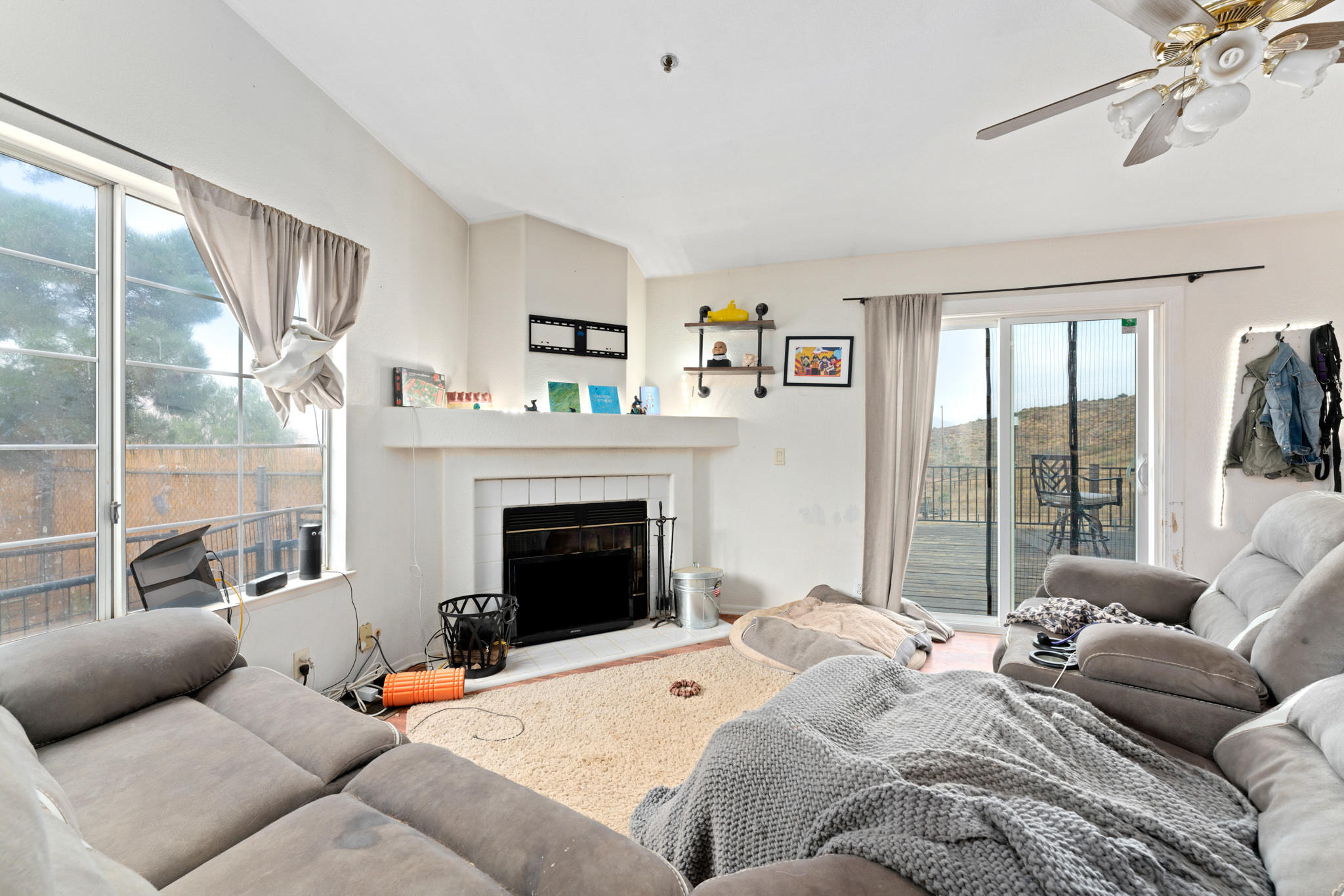 32035 Mountain Shadow Road Acton, CA 93510 - Photo 14 of 34 a living room with furniture a large window and a fireplace