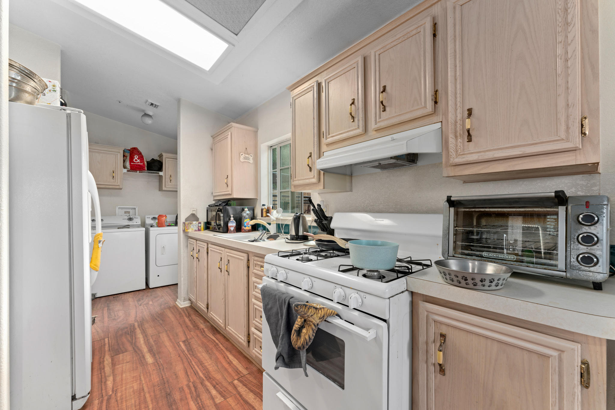 32035 Mountain Shadow Road Acton, CA 93510 - Photo 16 of 34 a kitchen with white cabinets and white appliances